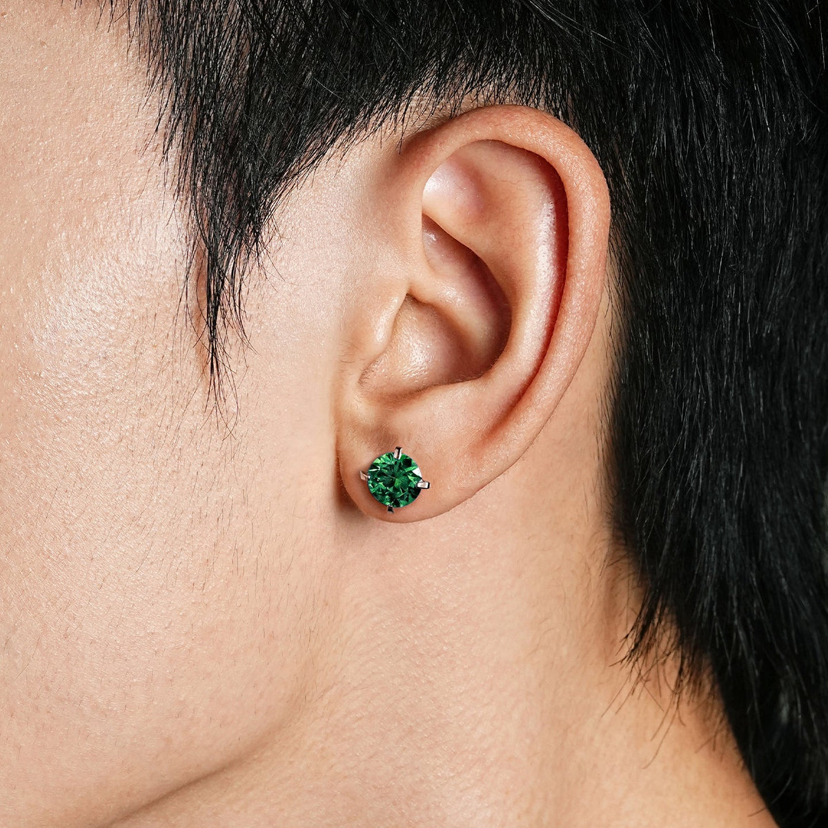 Green stone sterling silver studs worn profile view