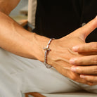 Twisted cross bracelet worn close on wrist