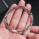 Oxidized silver link bracelet worn on wrist