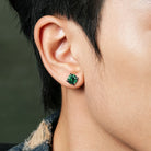 Green cubic zirconia silver stud earrings angled pair